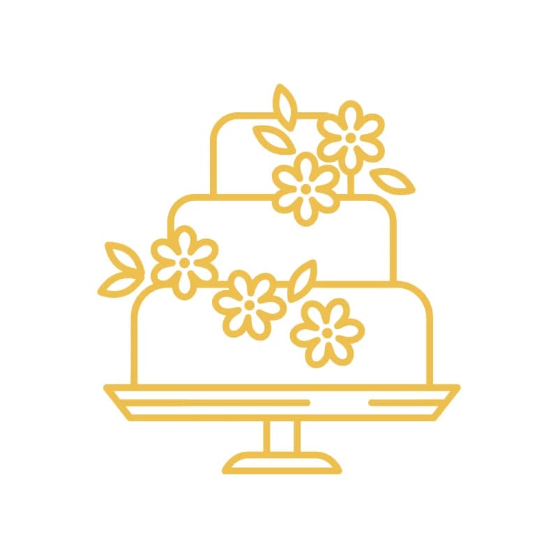 Beautiful floral arrangement next to a freshly baked decorated cake